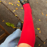 Woman wear red cotton knee high compression sock and black leather loafers