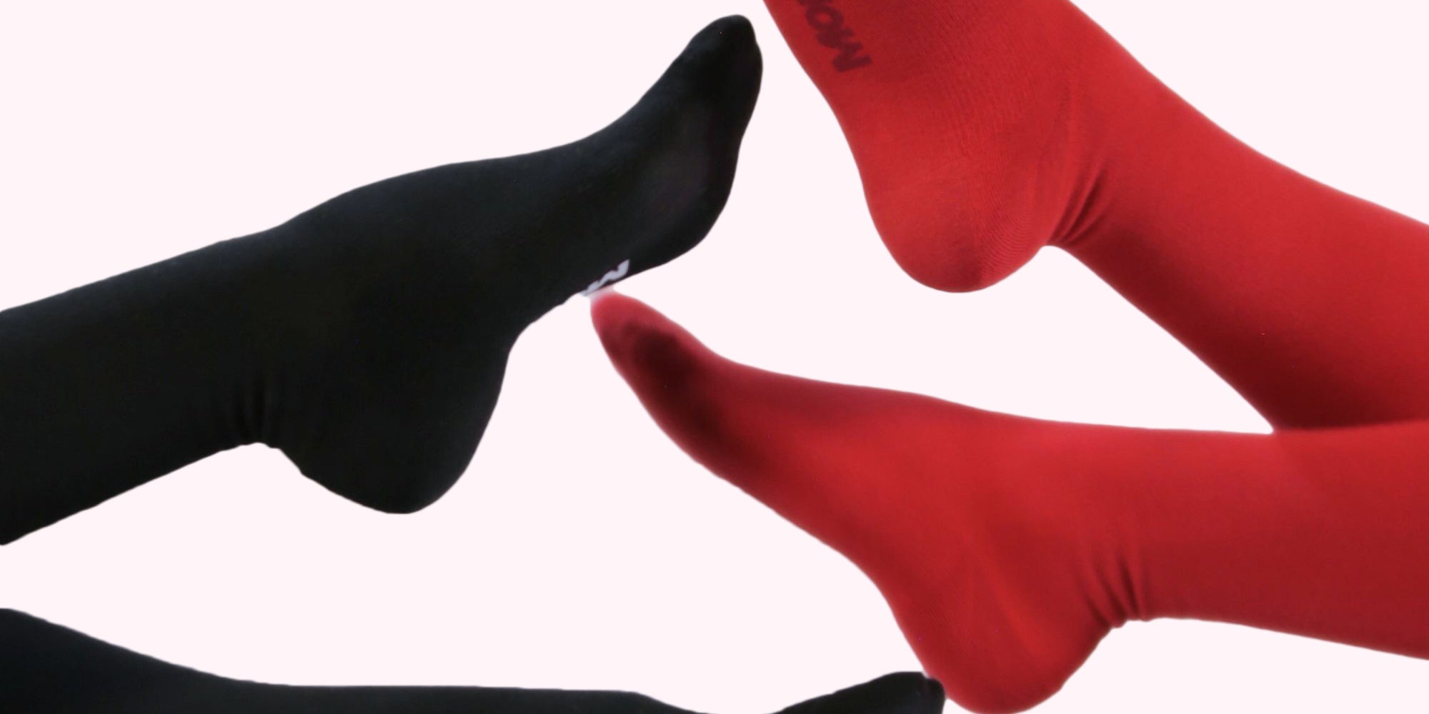 Two legs wearing socks, one in black and one in red, posed against a light pink background. The brand name 'MOON' is visible on the soles of both socks.