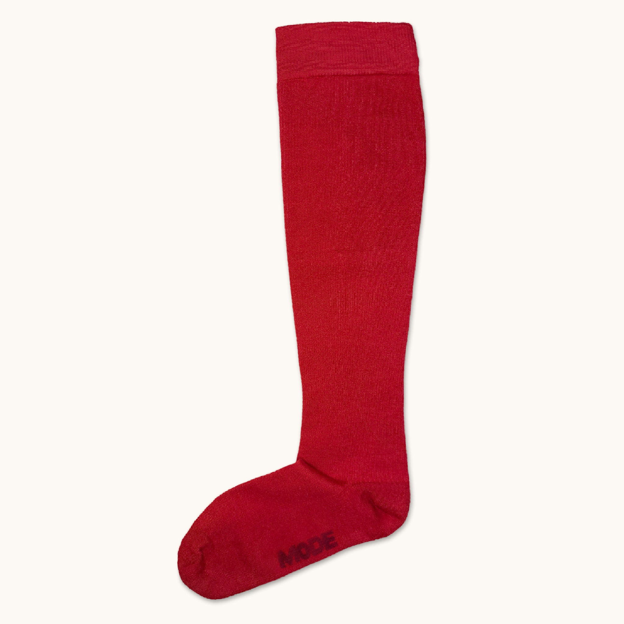 Red knee-high compression sock on a white background