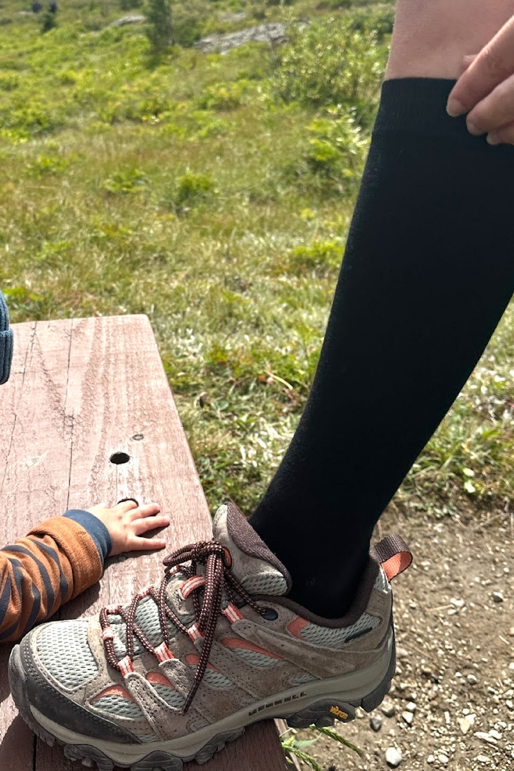 woman wearing black cotton knee high compression socks with and hiking boots